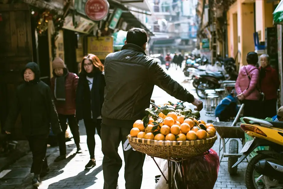 a_busy_street_scene_in_hanoi_with_a_vendor_selling_fresh_oranges.webp