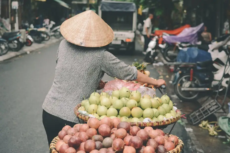 a_traditional_vendor_in_hanoi_sells_fresh_fruit_on_a_bustling_street_m.webp