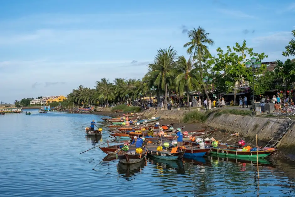 Colorful Boats Along Palm Lined Riverside In Hoi An A Vibrant Scene In