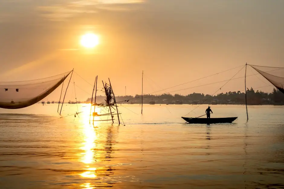silhouette of person rowing boat near fishing nets on river