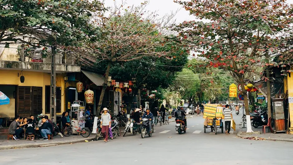 vibrant_street_in_h_i_an_with_people_bikes_and_shops_under_leafy_trees.webp